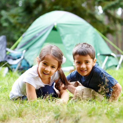 2 kids in front of their tent