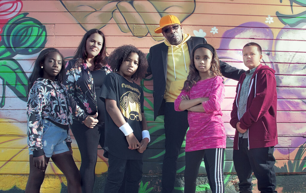 Photo of the Alphabet Rockers with kids who are part of the band.