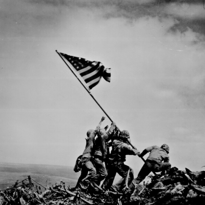 Iconic photo by Joe Rosenthal showing the raising of the United States flag over Iwo Jima.
