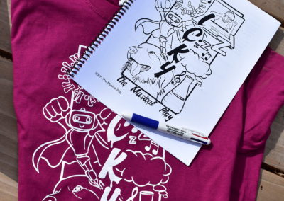A photo of the ICKY t-shirt and script with a Children's Hour 4 color pen atop the pile.